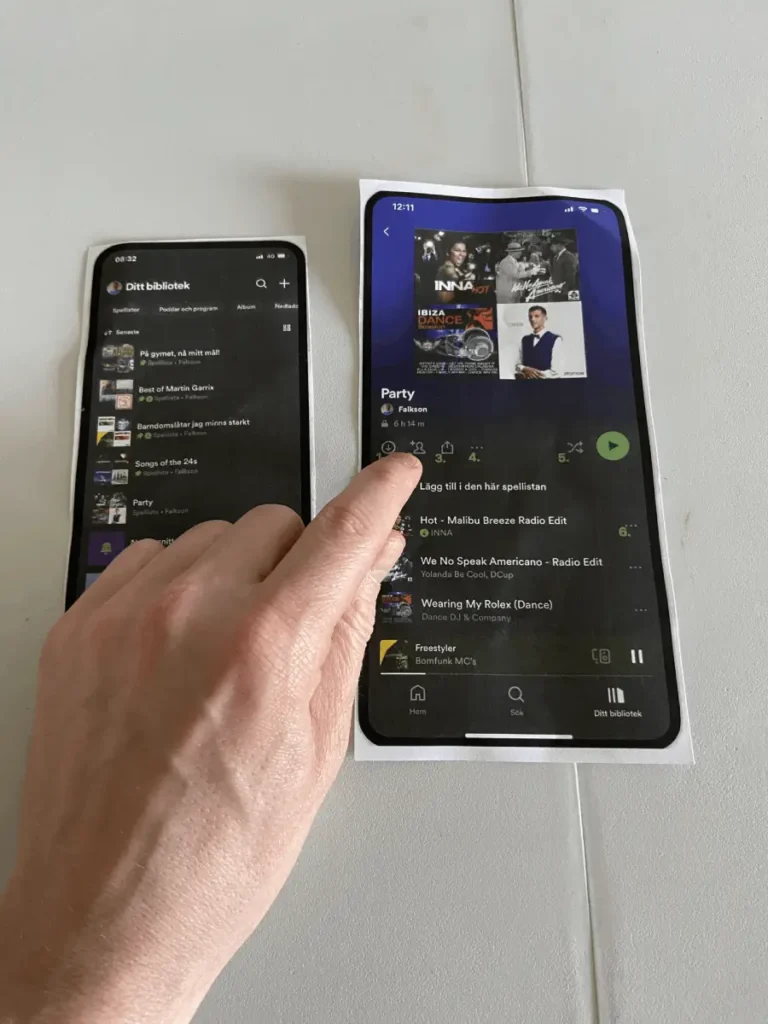 A user tests icons on a printed Spotify playlist during a usability test