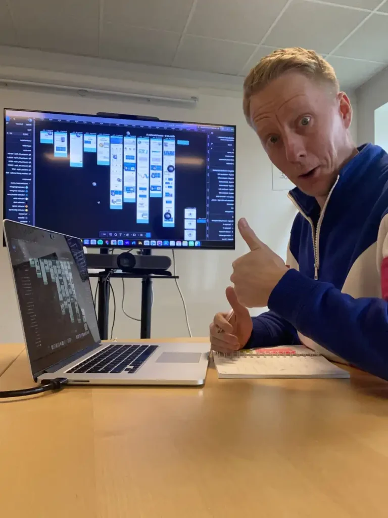 Andreas Falkson Falk showcasing prototype on a TV and laptop