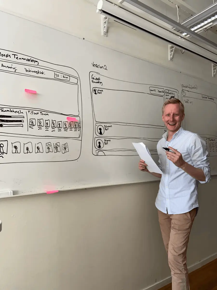Andreas Falkson Falk making wireframes on a whiteboard to showcase a potential design
